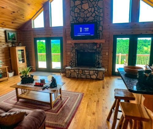 a living room with a fireplace and a tv at Over The River in West Jefferson