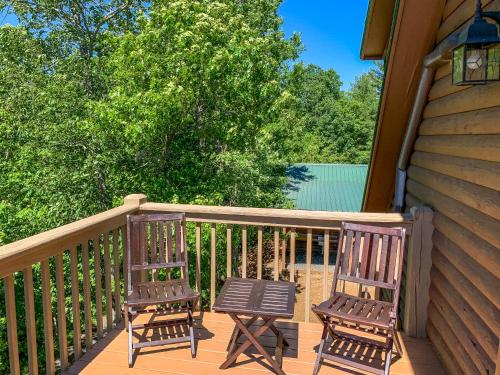two chairs and a table on a deck at Over The River in West Jefferson