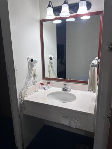 a bathroom with a sink and a mirror at FairBridge Inn & Suites Sunnyside in Sunnyside