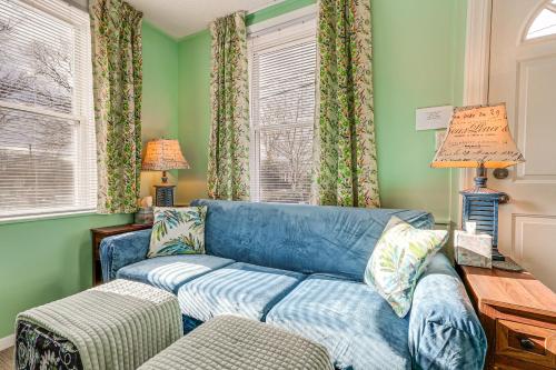 a blue couch in a living room with green walls at Wolcott Home with Deck Near Connecticut Attractions in Wolcott