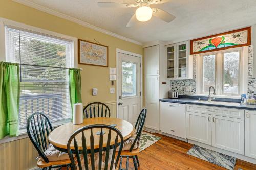 a kitchen with a table and chairs and a sink at Wolcott Home with Deck Near Connecticut Attractions in Wolcott