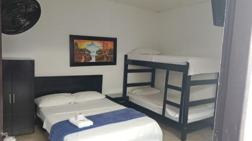 a room with two bunk beds and a bed at HOTEL LUZ MERY in Aguachica