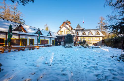 a large house with snow on the ground at Wellness Vila Astra in Stará Lesná