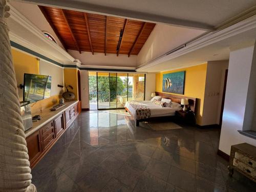 a large room with a bed and a sink at Porto Bello Hotel Boutique in Puerto Colombia
