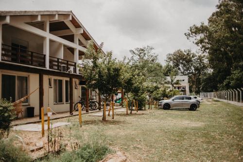 a car parked in front of a house at Pousada Recanto das Cerejeiras in Rio Grande