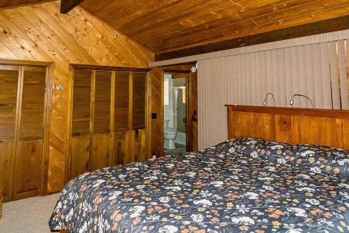 a bedroom with a bed and a wooden ceiling at The Badger House in Badger