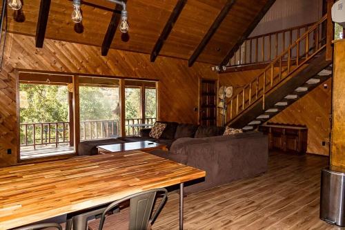 a living room with a table and a couch at The Badger House in Badger