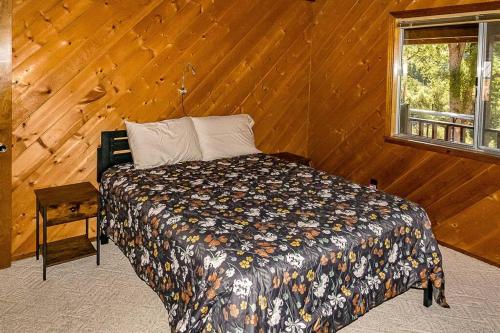 a bedroom with a bed in a wooden wall at The Badger House in Badger