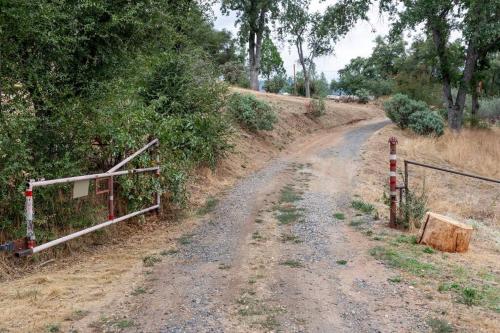 a dirt road with a fence on the side at The Badger House in Badger