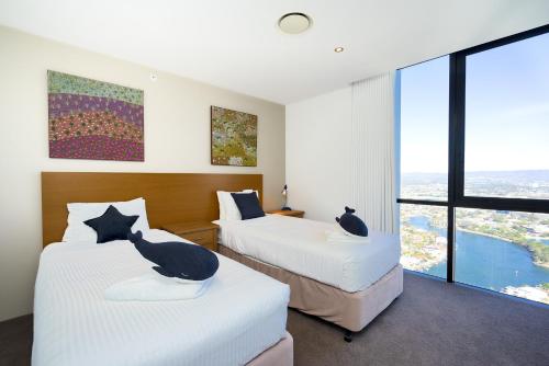 - une chambre d'hôtel avec 2 lits avec des chats dans l'établissement 3BR Circle On Cavill 52nd Floor Spacious Skyhome Apart, à Gold Coast