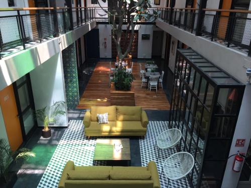 a living room with yellow couches and a table at Mini loft Buenavista 208 in Mexico City