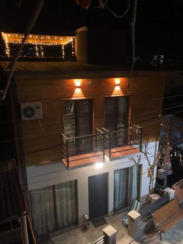a building with a balcony with lights on it at Borjomi inn in Borjomi