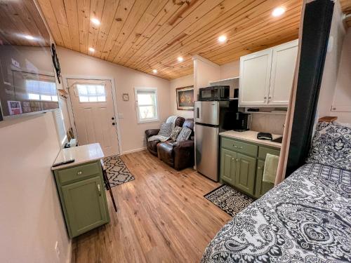 a small kitchen and living room in a tiny house at Petite Retreat in West Jefferson