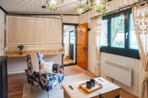 a living room with a large screen in a house at Le Chalet Bed&Bath -Chez Les Alfreds in Soubey
