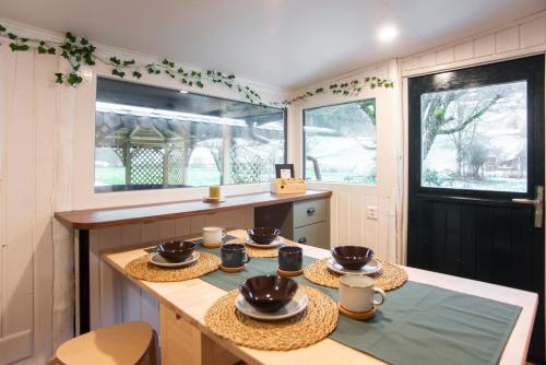a kitchen with a table with bowls on it at Le Chalet Bed&Bath -Chez Les Alfreds in Soubey