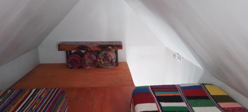 a attic room with a table and a bed at Cabaña Ermelinda in San Carlos de Bariloche