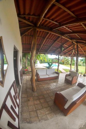 a living room with couches and a large roof at Tarcoles Birding Lodge in Tarcoles