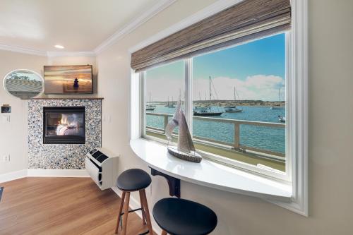 a room with a large window with a view of the water at Estero Inn in Morro Bay
