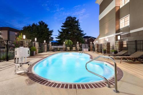 a large swimming pool in a courtyard of a building at Holiday Inn Express - Bowling Green by IHG in Bowling Green