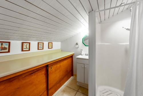 a bathroom with a sink and a shower at Turtle Bay Townhouse Steps to Our Beautiful Beach! in Kahuku