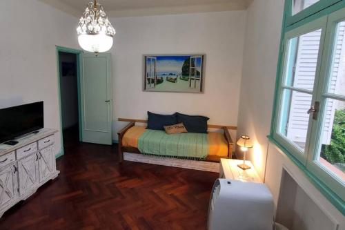a bedroom with a bed and a flat screen tv at Comfortable Apartment in Colegiales in Buenos Aires