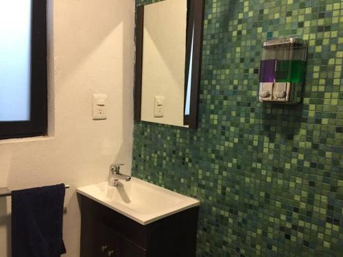 a bathroom with a sink and a mirror at Mini Loft 107 in Mexico City