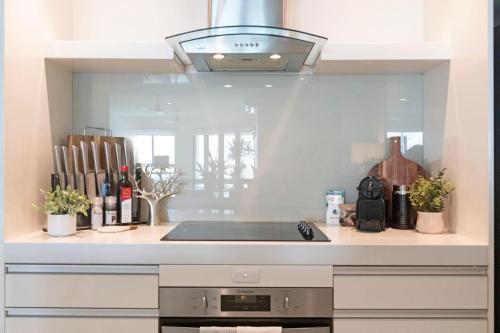 a kitchen with a sink and a stove at 'High-Top Retreat' City Chic With Ocean Outlooks in Darwin