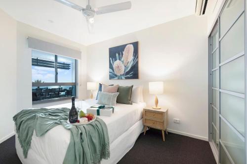 a bedroom with a bed with a table and a window at 'High-Top Retreat' City Chic With Ocean Outlooks in Darwin