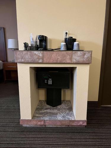a fireplace in a hotel room with a counter at Country Inn & Suites by Radisson, Battle Creek, MI in Battle Creek