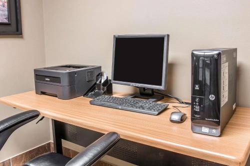 a desk with a computer and a printer on it at Country Inn & Suites by Radisson, Battle Creek, MI in Battle Creek