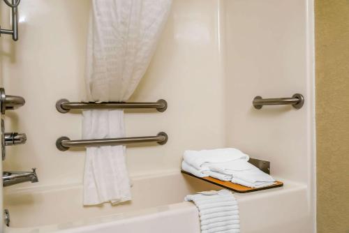 a bathroom with a bath tub with towels at Country Inn & Suites by Radisson, Stillwater, MN in Stillwater