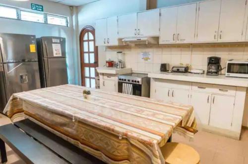 a kitchen with a large table in the middle of it at Private Room in Urdesa Central Guayaquil in Guayaquil