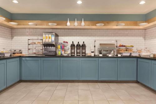 a kitchen with blue cabinets and a counter top at Country Inn & Suites by Radisson, Fresno North, CA in Fresno