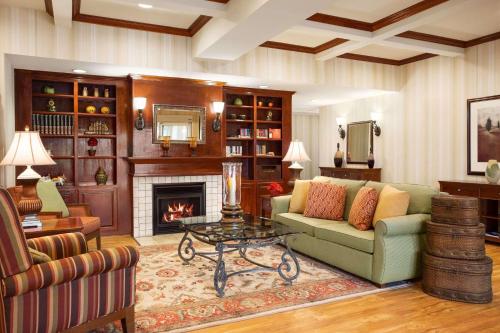 a living room with a couch and a fireplace at Country Inn & Suites by Radisson, Conway, AR in Conway