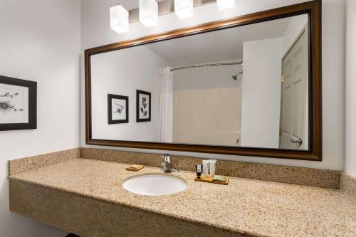 a bathroom with a sink and a large mirror at Country Inn & Suites by Radisson, Boise West, ID in Meridian