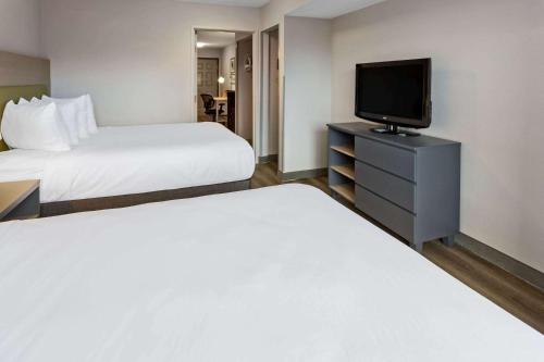 a hotel room with two beds and a flat screen tv at Country Inn & Suites by Radisson, Salisbury, MD in Salisbury