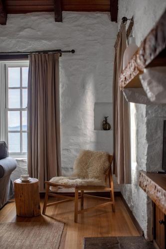 a living room with a chair and a window at Piermont Retreat in Swansea