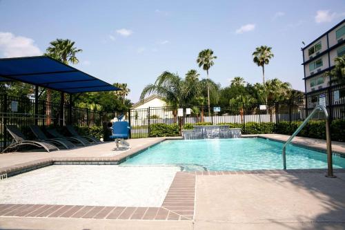 a swimming pool with a fountain in a building at Radisson Hotel McAllen Airport in McAllen
