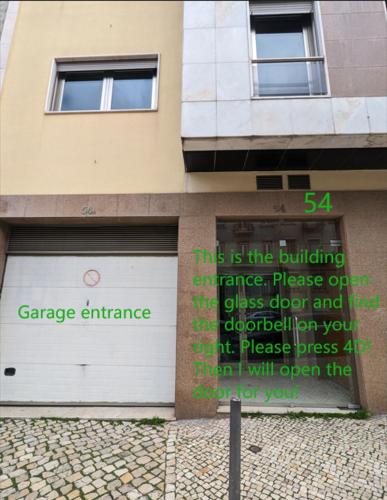 a sign in front of a building with a garage entrance at luxury lisbon apartment T2 in Lisbon