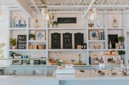 a coffee shop with a counter and a shelf with plants at The Lighthouse Boutique Hotel in Port Isabel