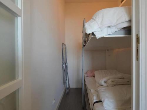 a room with a bunk bed in a room with a door at West31 with beautiful sea views in Oostduinkerke