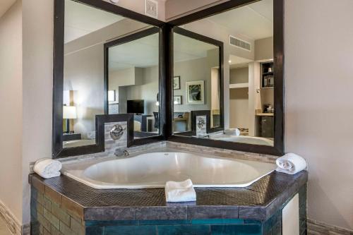 a bathroom with a large tub with a large mirror at Country Inn & Suites by Radisson, Mesa, AZ in Mesa