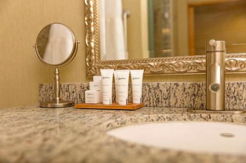 a bathroom counter with a sink and a mirror at Radisson Hotel Yuma in Yuma