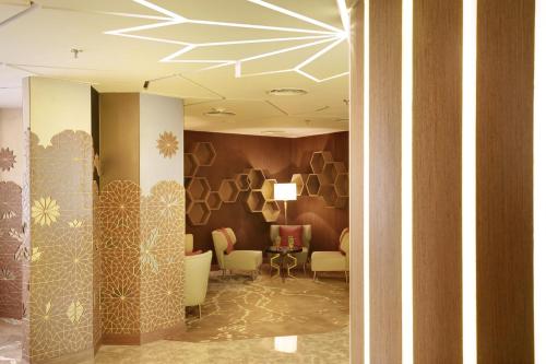 a lobby with a waiting room with a table and chairs at Crowne Plaza Dhaka Gulshan by IHG in Dhaka