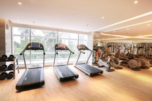 a gym with treadmills and ellipticals in a room at Crowne Plaza Dhaka Gulshan by IHG in Dhaka
