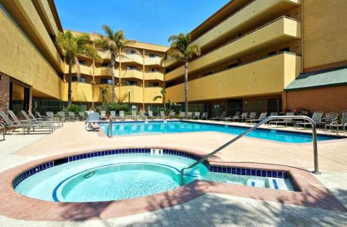 a large swimming pool in a hotel with a person at Radisson Hotel Santa Maria in Santa Maria