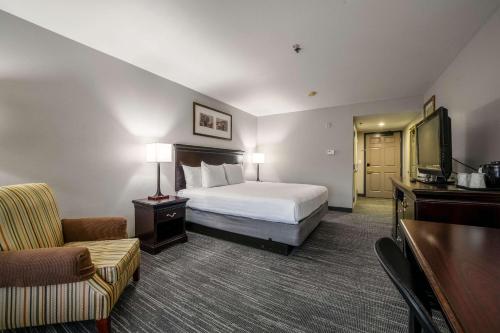 a hotel room with a bed and a television at Country Inn & Suites by Radisson, Ontario at Ontario Mills, CA in Ontario