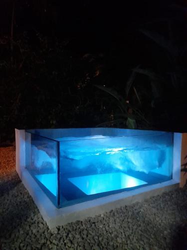 a blue aquarium sitting on the ground at night at Casa Namaste del Pacifico - Luxury Villa in Santa Teresa Beach