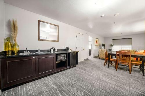 a kitchen with a sink and a dining room at Country Inn & Suites by Radisson, Ontario at Ontario Mills, CA in Ontario