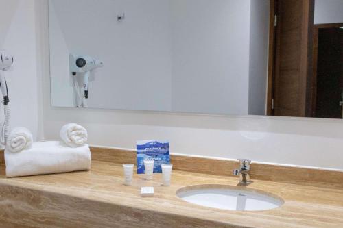 a bathroom counter with a sink and a mirror at Park Inn by Radisson Los Olivos de Vallenar in Vallenar